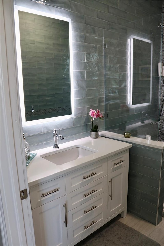 24197 Treasure Island Blvd, Punta Gorda, FL 33955 - bathroom with vanity, tile walls, and tasteful backsplash