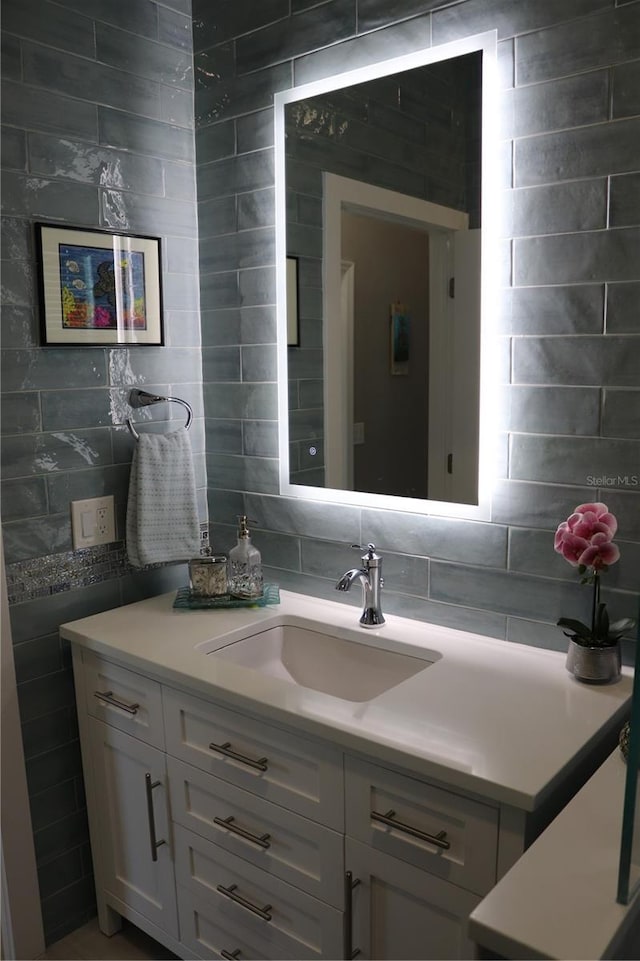 24197 Treasure Island Blvd, Punta Gorda, FL 33955 - bathroom with vanity, decorative backsplash, and tile walls