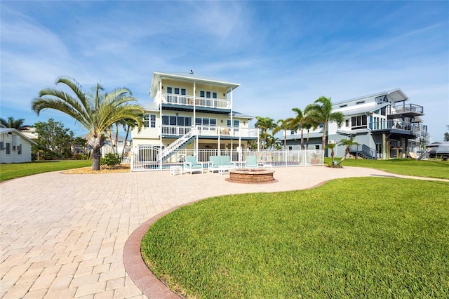 24197 Treasure Island Blvd, Punta Gorda, FL 33955 - back of house featuring an outdoor fire pit, a patio, stairs, and a balcony