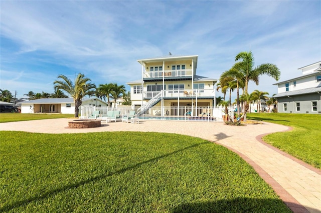 24197 Treasure Island Blvd, Punta Gorda, FL 33955 - rear view of property with an outdoor fire pit, stairway, a patio, and a balcony