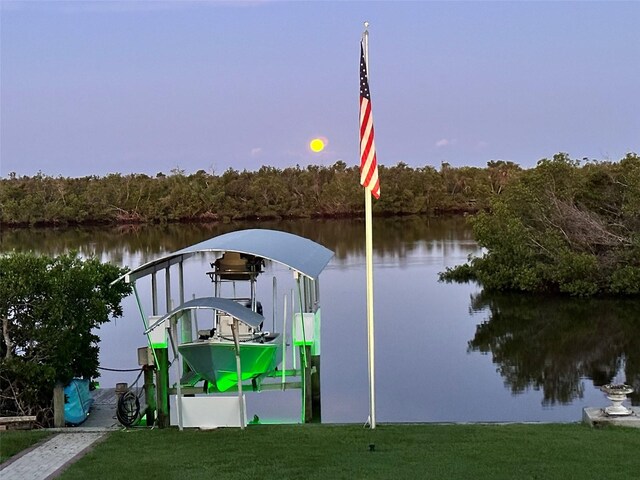 24197 Treasure Island Blvd, Punta Gorda, FL 33955 - dock with a water view, a yard, a forest view, and boat lift