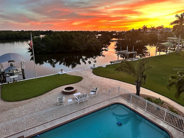 24197 Treasure Island Blvd, Punta Gorda, FL 33955 - view of pool featuring a fire pit, a water view, a patio, and a boat dock