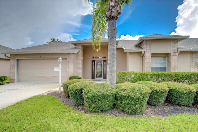 1210 Wolford Dr, Trinity, FL 34655 - view of front of home featuring concrete driveway, an attached garage, brick siding, and stucco siding