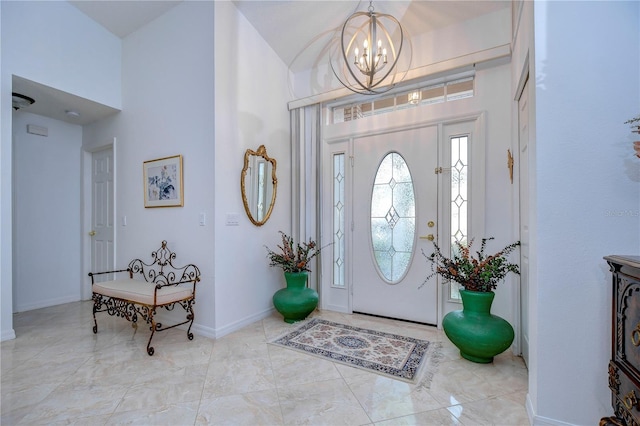 1210 Wolford Dr, Trinity, FL 34655 - foyer with a chandelier, high vaulted ceiling, and baseboards