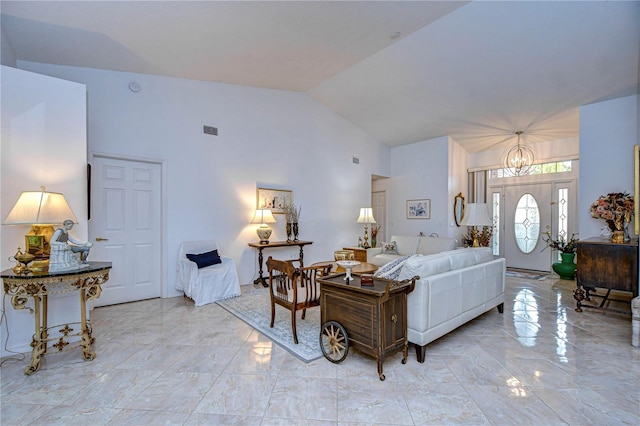 1210 Wolford Dr, Trinity, FL 34655 - living area featuring light marble finish flooring, a chandelier, and high vaulted ceiling
