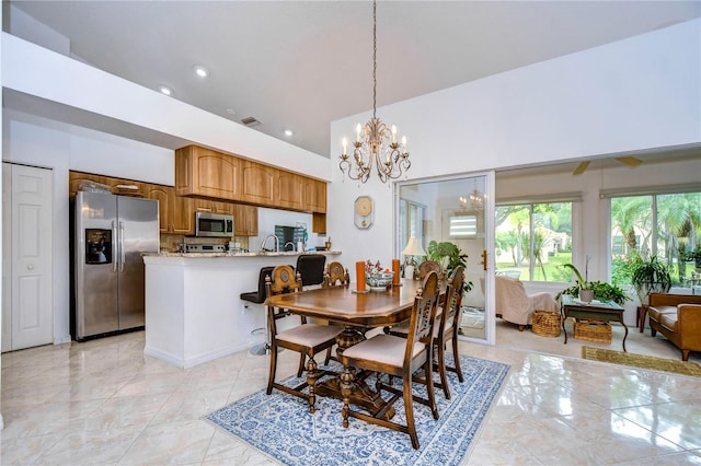 1210 Wolford Dr, Trinity, FL 34655 - dining area with a chandelier, light marble finish floors, and recessed lighting