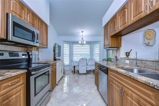 1210 Wolford Dr, Trinity, FL 34655 - kitchen with stainless steel appliances, a sink, light stone counters, brown cabinets, and a textured ceiling