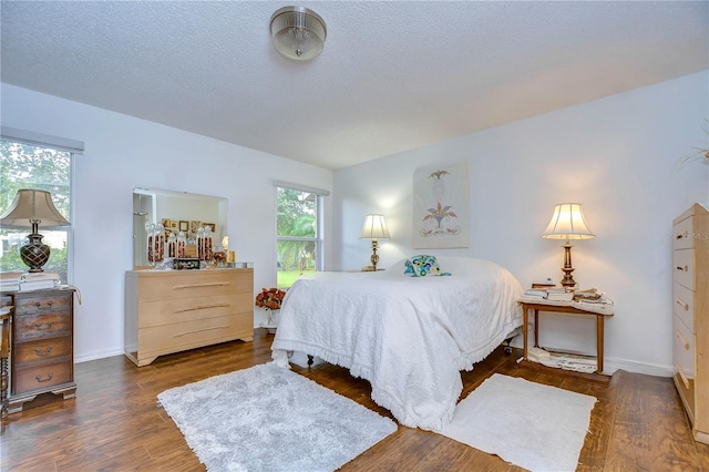 1210 Wolford Dr, Trinity, FL 34655 - bedroom featuring wood finished floors, baseboards, and a textured ceiling