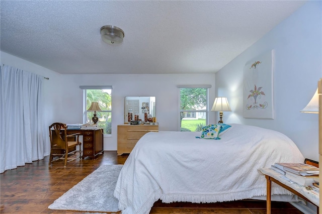 1210 Wolford Dr, Trinity, FL 34655 - bedroom with wood finished floors and a textured ceiling