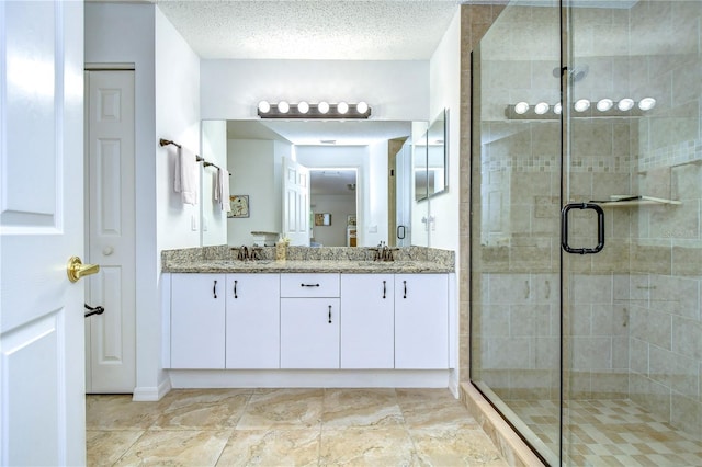 1210 Wolford Dr, Trinity, FL 34655 - bathroom featuring double vanity, a shower stall, a textured ceiling, and baseboards