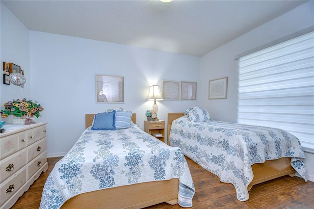 1210 Wolford Dr, Trinity, FL 34655 - bedroom featuring dark wood-type flooring and baseboards
