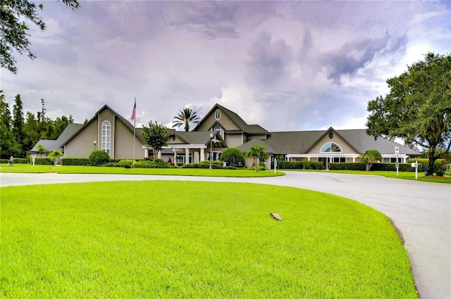 1210 Wolford Dr, Trinity, FL 34655 - view of front of home featuring curved driveway, a front lawn, and stucco siding
