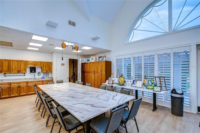 1210 Wolford Dr, Trinity, FL 34655 - dining space featuring light wood-type flooring and high vaulted ceiling