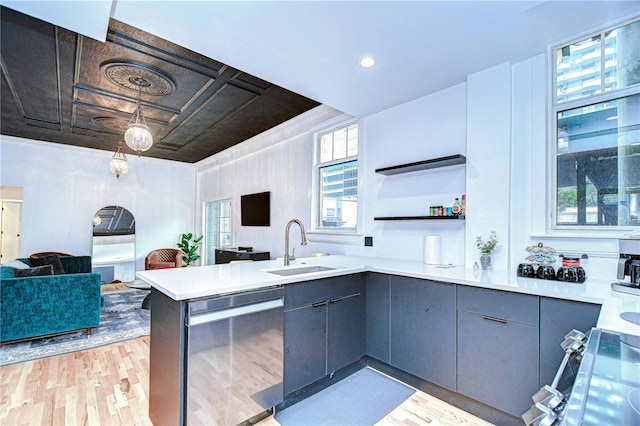 215 Central Ave Unit 2B, Saint Petersburg, FL 33701 - kitchen with stainless steel dishwasher, open floor plan, a sink, and light wood-style flooring