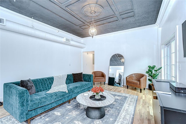 215 Central Ave Unit 2B, Saint Petersburg, FL 33701 - living room featuring wood finished floors, an ornate ceiling, arched walkways, and ornamental molding