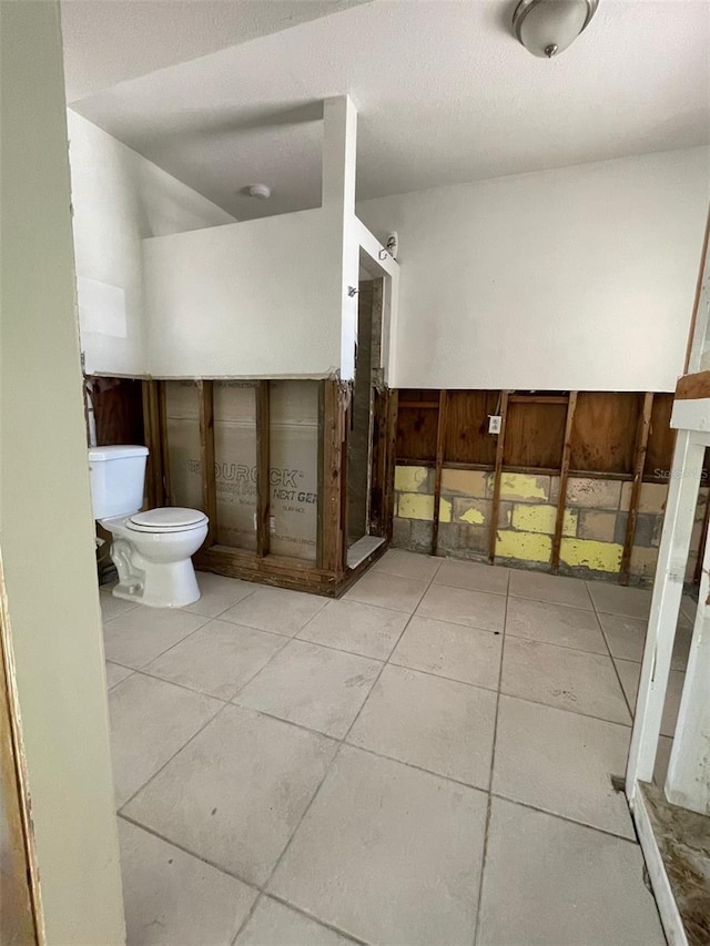 3207 S De Bazan Ave, St Pete Beach, FL 33706 - bathroom with toilet, a shower stall, and tile patterned floors