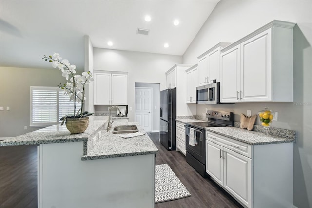 13227 Quigley Ave, Weeki Wachee, FL 34614 - kitchen with black appliances, a sink, vaulted ceiling, white cabinetry, and dark wood-style flooring