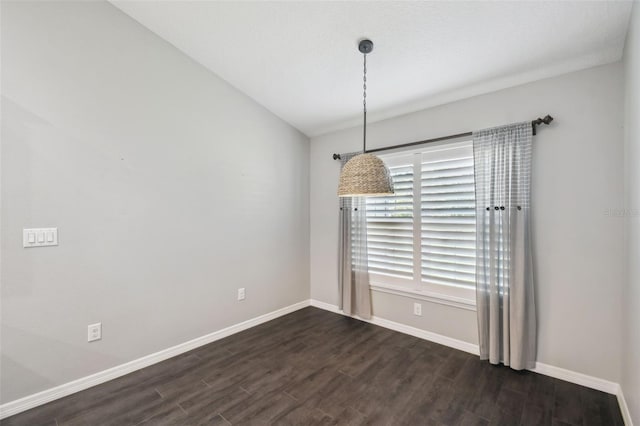 13227 Quigley Ave, Weeki Wachee, FL 34614 - empty room with dark wood-style floors, baseboards, and lofted ceiling
