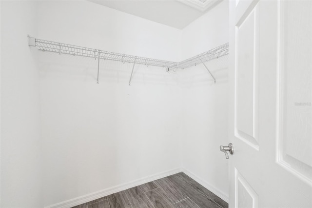 13227 Quigley Ave, Weeki Wachee, FL 34614 - walk in closet featuring dark wood finished floors
