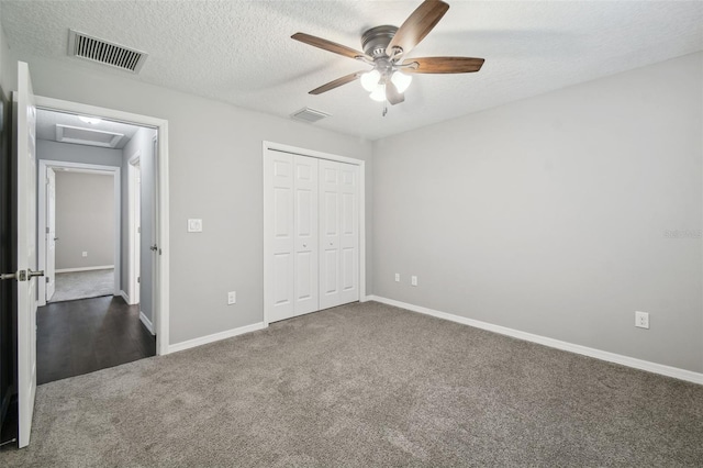 13227 Quigley Ave, Weeki Wachee, FL 34614 - unfurnished bedroom featuring carpet flooring, attic access, a textured ceiling, baseboards, and a closet