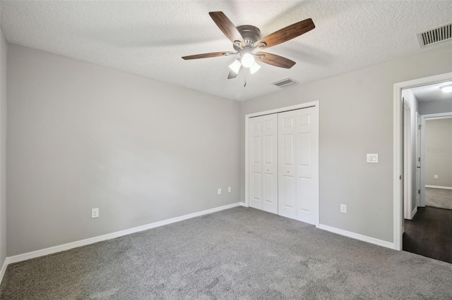 13227 Quigley Ave, Weeki Wachee, FL 34614 - unfurnished bedroom featuring carpet floors, baseboards, a closet, a textured ceiling, and ceiling fan