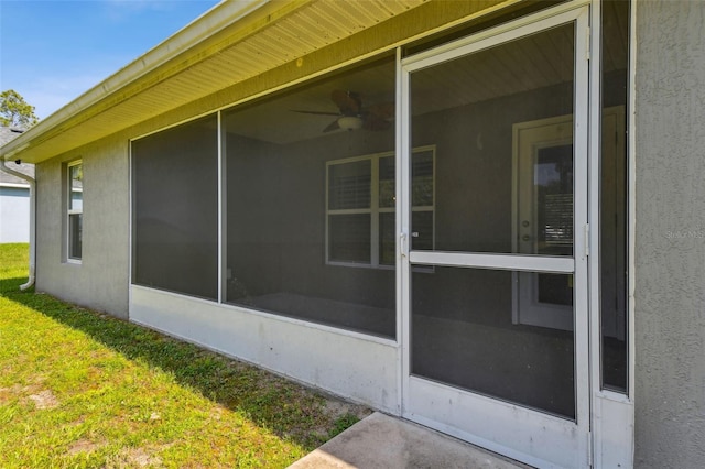 13227 Quigley Ave, Weeki Wachee, FL 34614 - view of home's exterior with stucco siding, a sunroom, and a lawn