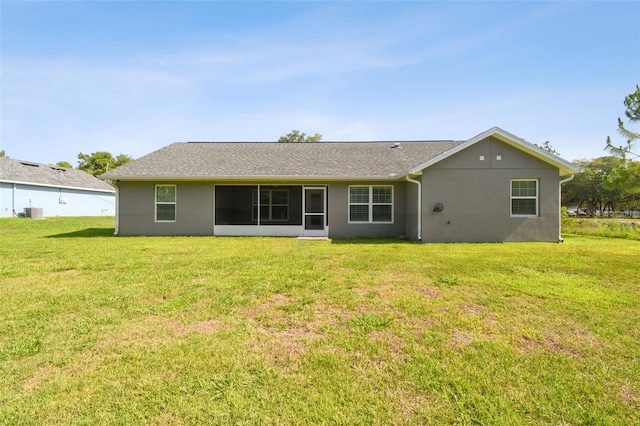 13227 Quigley Ave, Weeki Wachee, FL 34614 - rear view of property featuring a yard, stucco siding, and central air condition unit