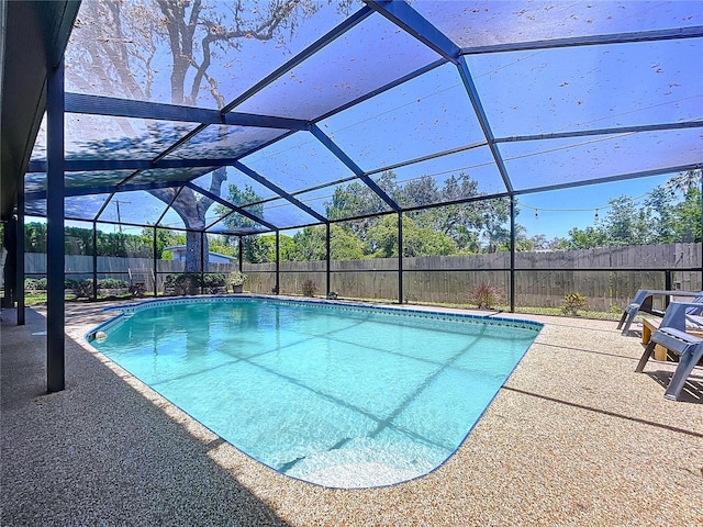 1445 Stonehenge Way, Palm Harbor, FL 34683 - view of swimming pool featuring a fenced backyard, a patio, and glass enclosure