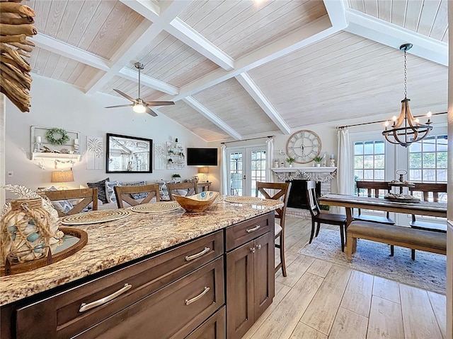 1445 Stonehenge Way, Palm Harbor, FL 34683 - kitchen with light wood-style flooring, french doors, a chandelier, light stone counters, and hanging light fixtures