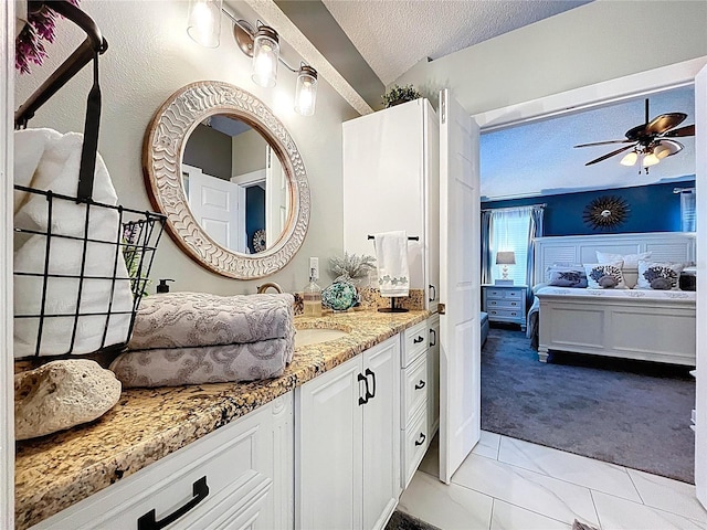 1445 Stonehenge Way, Palm Harbor, FL 34683 - bathroom featuring connected bathroom, vanity, a textured ceiling, and a ceiling fan