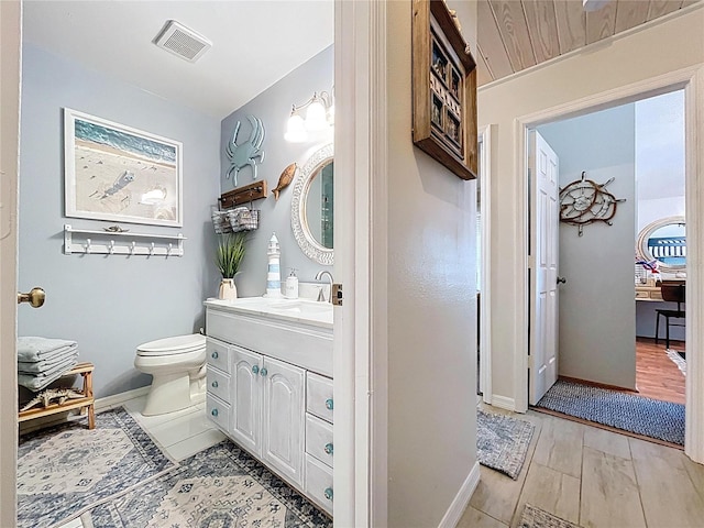 1445 Stonehenge Way, Palm Harbor, FL 34683 - bathroom featuring vanity, toilet, and baseboards