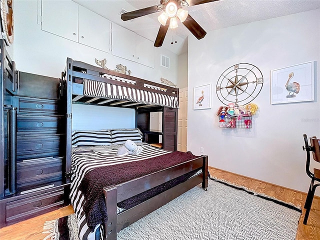 1445 Stonehenge Way, Palm Harbor, FL 34683 - bedroom with wood finished floors, vaulted ceiling, and a ceiling fan