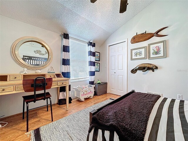 1445 Stonehenge Way, Palm Harbor, FL 34683 - bedroom with a textured ceiling, wood finished floors, lofted ceiling, and a ceiling fan