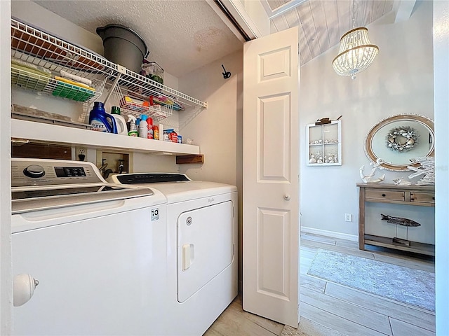 1445 Stonehenge Way, Palm Harbor, FL 34683 - laundry room featuring washer and clothes dryer, a chandelier, and baseboards