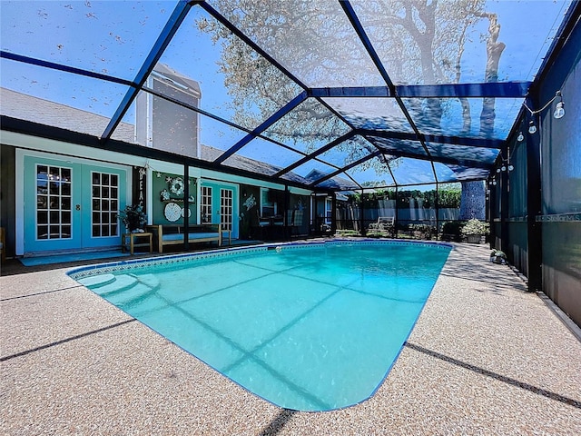 1445 Stonehenge Way, Palm Harbor, FL 34683 - outdoor pool with french doors, a patio area, and glass enclosure