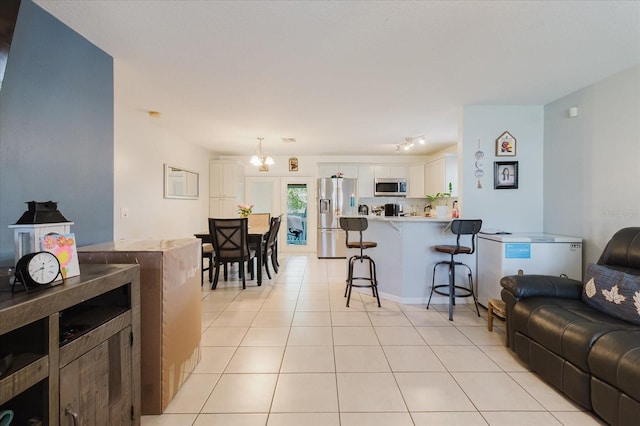 8517 N Branch Ave, Tampa, FL 33604 - living area with light tile patterned floors and a chandelier