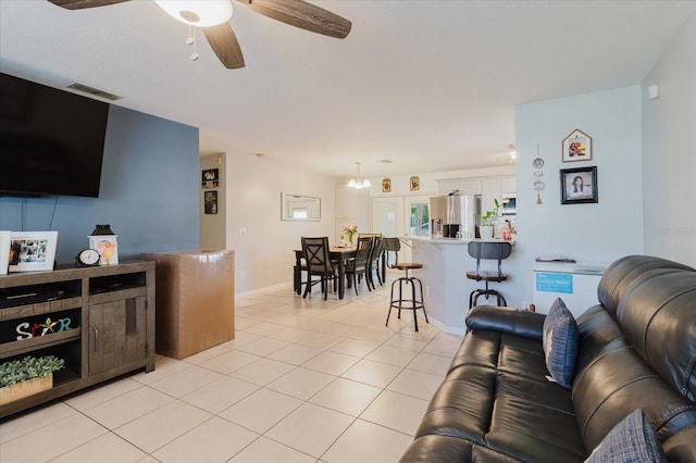 8517 N Branch Ave, Tampa, FL 33604 - living area with a ceiling fan, light tile patterned flooring, and baseboards