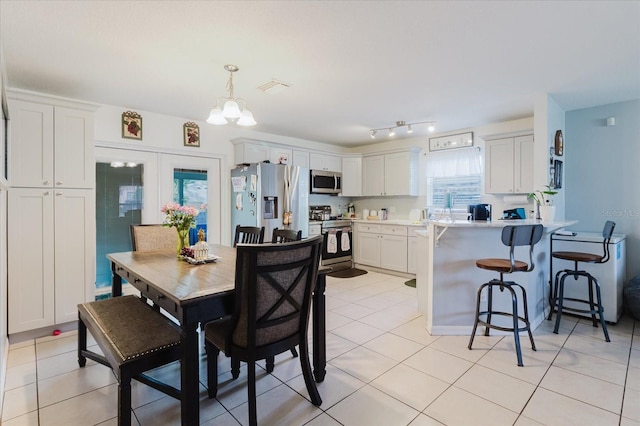 8517 N Branch Ave, Tampa, FL 33604 - dining room featuring light tile patterned floors