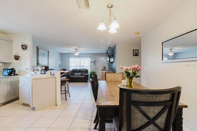 8517 N Branch Ave, Tampa, FL 33604 - dining space with a ceiling fan, light tile patterned floors, and a chandelier