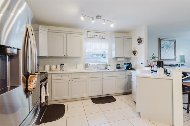 8517 N Branch Ave, Tampa, FL 33604 - kitchen with stainless steel fridge with ice dispenser, tasteful backsplash, light countertops, a sink, and light tile patterned flooring