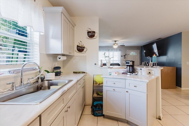 8517 N Branch Ave, Tampa, FL 33604 - kitchen featuring a sink, light tile patterned floors, light countertops, and ceiling fan