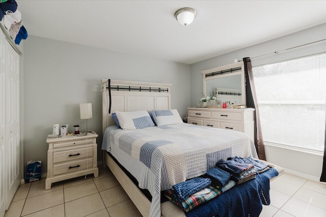 8517 N Branch Ave, Tampa, FL 33604 - bedroom featuring light tile patterned floors, a closet, and baseboards