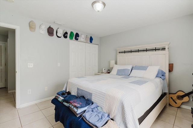 8517 N Branch Ave, Tampa, FL 33604 - bedroom featuring light tile patterned floors, a closet, and baseboards