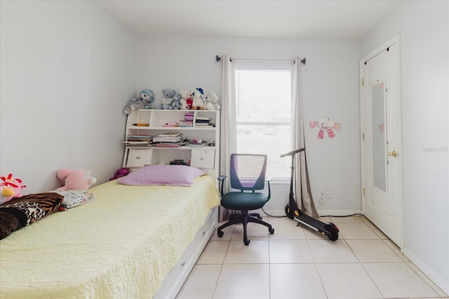 8517 N Branch Ave, Tampa, FL 33604 - bedroom featuring multiple windows, light tile patterned floors, and baseboards