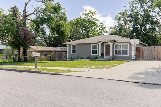8517 N Branch Ave, Tampa, FL 33604 - ranch-style house featuring stucco siding and driveway