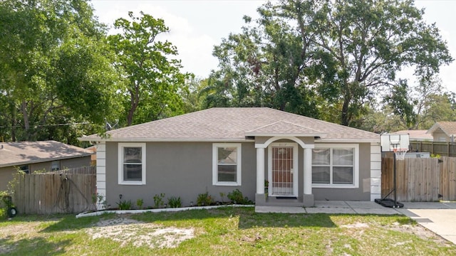 8517 N Branch Ave, Tampa, FL 33604 - ranch-style home featuring stucco siding and roof with shingles
