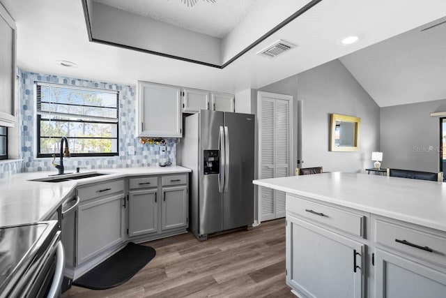 609 Lively Dr Unit B, Sun City Center, FL 33573 - kitchen featuring stainless steel fridge, a sink, backsplash, wood finished floors, and light countertops