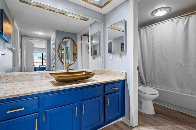 609 Lively Dr Unit B, Sun City Center, FL 33573 - full bathroom with wood finished floors, vanity, toilet, and shower / bathtub combination with curtain