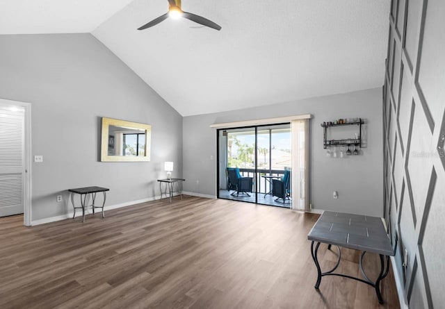 609 Lively Dr Unit B, Sun City Center, FL 33573 - living area with ceiling fan, high vaulted ceiling, wood finished floors, and baseboards