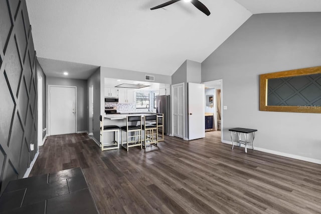 609 Lively Dr Unit B, Sun City Center, FL 33573 - kitchen featuring stainless steel appliances, high vaulted ceiling, ceiling fan, a breakfast bar, and white cabinets